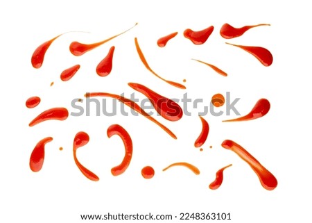 Set of red drops and splashes of ketchup or sauce isolated on white background. With clipping path. Full depth of field. Focus stacking