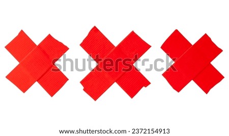 Set of red scotch tape or adhesive vinyl tape in stripe of crisscross shape is isolated on white background with clipping path.