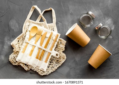 Set Of Reusable Items For Eco-friendly Lifestyle. Cotton Bag, Glass Jars, Wooden Tableware. Zero Waste, Organic Shopping Concept. Gray Background, Top Down