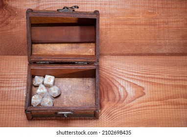 Set Of Role Playing White Dices Lie In Open Storage Box On Gaming Table Made Of Wood, Banner: Concept For Role-playing Games With Place For Text, Top View