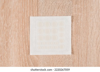 Set Of Round Acne Patches On Wooden Background. Close-up Acne Patch Facial Rejuvenation. Facial Cleansing Cosmetology