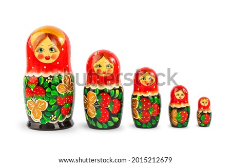 a set of Russian folk wooden dolls covered with patterns, isolate on a white background