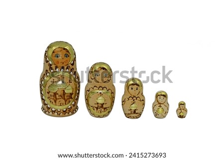 A set of Russian matryoshkas, each of this set of brightly painted hollow wooden dolls of varying sizes, designed to nest inside one