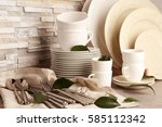 Set of rustic dinnerware on light brick background