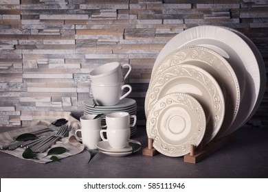Set of rustic dinnerware on light brick background