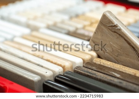 A set of samples of stones for decorative interior decoration. Beautiful set of marble and granite with stains, onyx surface. Finishing stone for furniture and interior.