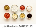 Set of sauces in bowls - pesto salsa mustard and others. Food background.