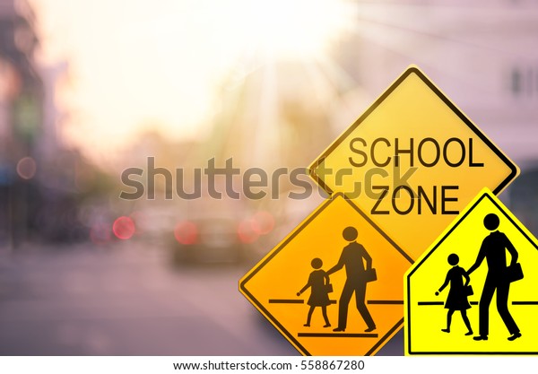 Set of\
School zone warning sign on blur traffic road with colorful bokeh\
light abstract background. Copy space of transportation and travel\
concept. Vintage tone filter color\
style.
