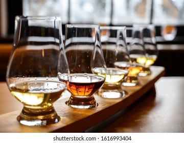 Set of Scottish whisky, tasting glasses with variety of single malts or blended whiskey spirits on distillery tour in Scotland, UK