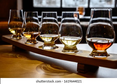 Set of Scottish whisky, tasting glasses with variety of single malts or blended whiskey spirits on distillery tour in Scotland, UK - Shutterstock ID 1619644021