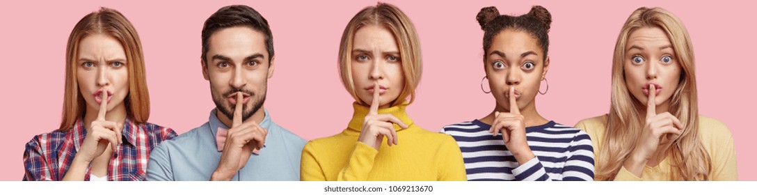 Set Of Serious Young Women And One Bearded Male Show Hush Sign, Demand To Be Quiet And Not Tell Secret, Keep Fingers On Lips. Pose Indoor Against Pink Background. People Say: Shh, Stop Talking