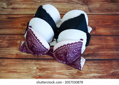 Set of sexy bras on a wooden background