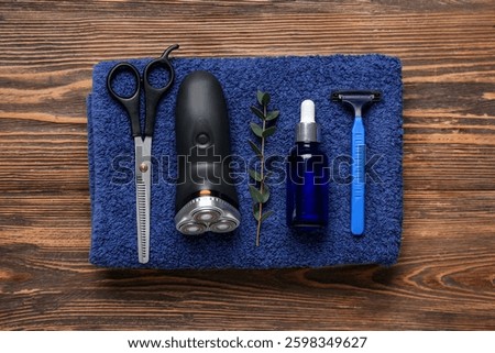 Set of shaving accessories on wooden background