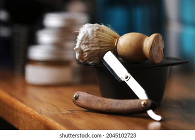 Set Of Shaving Equipment And Men's Cosmetic Products On Wooden Table, Barbershop. Shave Concept With A Straight Razor, Shaving Brush And Foam. Beard Care Products For Men On Background