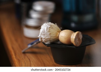 Set Of Shaving Equipment And Men's Cosmetic Products On Wooden Table, Barbershop. Shave Concept With A Straight Razor, Shaving Brush And Foam. Beard Care Products For Men On Background