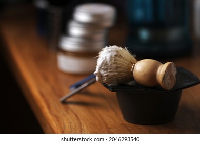 Set Of Shaving Equipment And Men's Cosmetic Products On Wooden Table, Barbershop. Shave Concept With A Straight Razor, Shaving Brush And Foam. Beard Care Products For Men On Background