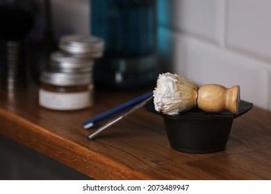 Set Of Shaving Equipment And Men's Cosmetic Products On Wooden Table, Barbershop. Shave Concept With A Straight Razor, Shaving Brush And Foam. Beard Care Products For Men On Background