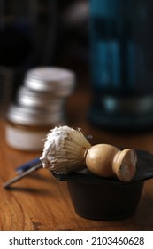 Set Of Shaving Equipment And Men's Cosmetic Products On Wooden Table, Barbershop. Shave Concept With A Straight Razor, Shaving Brush And Foam. Beard Care Products For Men On Background