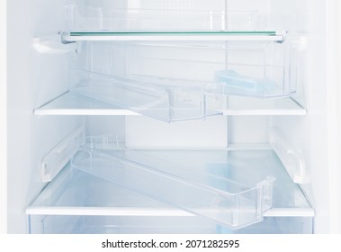 Set Of Shelves In A New White Refrigerator, Installation And Assembly