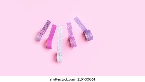 set of shiny sticky decorative tapes on pink background. bright washi tapes, stationery for scrapbooking, creativity, wrapping, festive packing. creative minimal style. template for design. banner