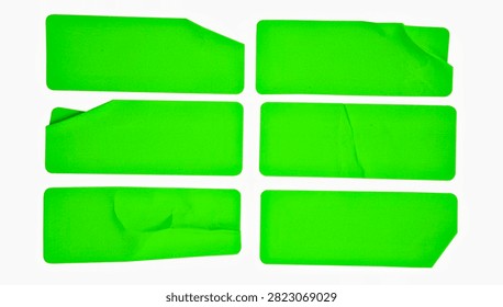 A set of six bright yellow rectangular paper sticker labels isolated on a white background. Some of the labels feature realistic folded edges and slightly torn corners that reveal the back.