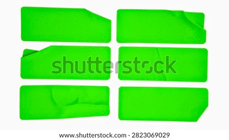 A set of six bright yellow rectangular paper sticker labels isolated on a white background. Some of the labels feature realistic folded edges and slightly torn corners that reveal the back.