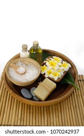 Set of soap.salt ,spoon, frangipani ,stones,brush ,bottle oil in wooden bowl on mat


 - Shutterstock ID 1070242937