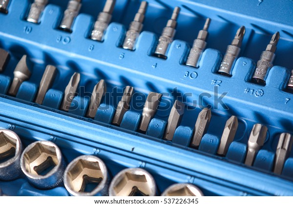 set of socket wrench and screw drivers in plastic\
box closeup