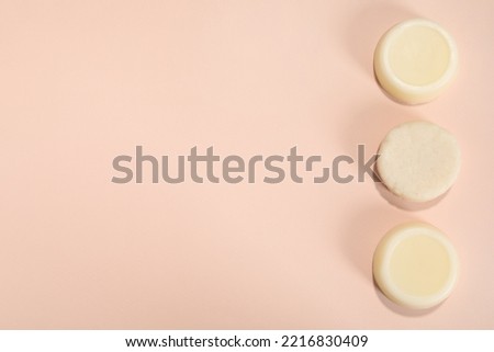 Set of solid shampoo bars on pink background, flat lay. Space for text
