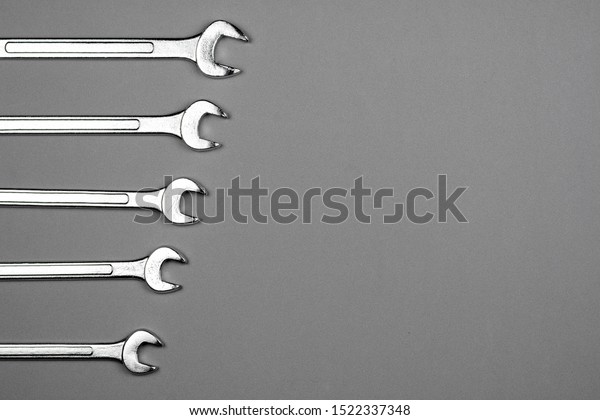 Set of spanner on grey desk background. -\
industrial workshop hand tools\
concept.