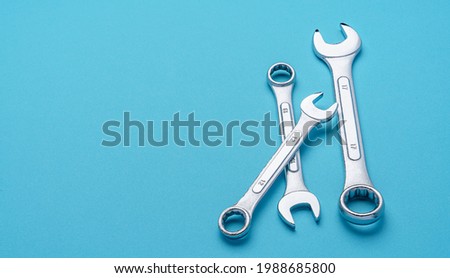 Set of spanners and wrenches on color background
