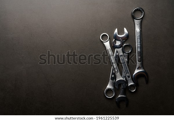 Set of\
spanners and wrenches on dark\
background