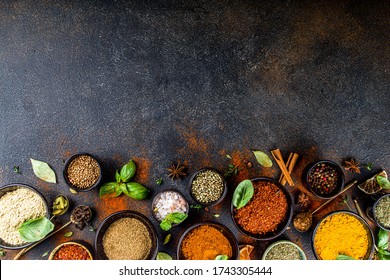 Set of Spices and herbs for cooking. Small bowls with colorful  seasonings and spices - basil, pepper, saffron, salt, paprika, turmeric. On black stone table top view copy space - Shutterstock ID 1743305444