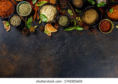 Set of Spices and herbs for cooking. Small bowls with colorful  seasonings and spices - basil, pepper, saffron, salt, paprika, turmeric. On black stone table top view copy space - Shutterstock ID 1743305603