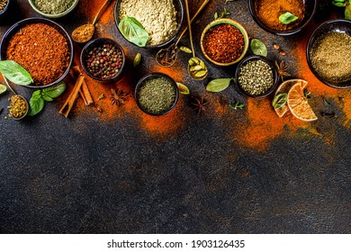 Set of Spices and herbs for cooking. Small bowls with colorful  seasonings and spices - basil, pepper, saffron, salt, paprika, turmeric. On black stone table top view copy space - Shutterstock ID 1903126435