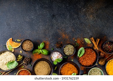 Set of Spices and herbs for cooking. Small bowls with colorful  seasonings and spices - basil, pepper, saffron, salt, paprika, turmeric. On black stone table top view copy space - Shutterstock ID 1931762159