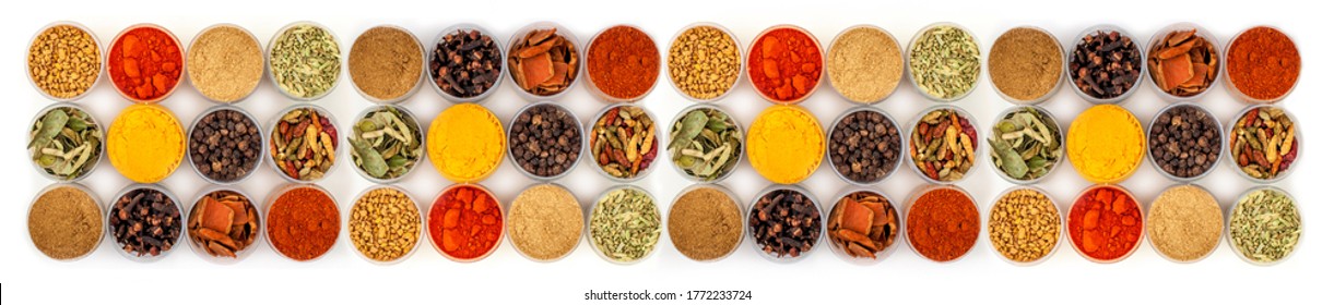 Set of spices in jars on a white background. A long banner of a variety of Indian spices, herbs, peppers.