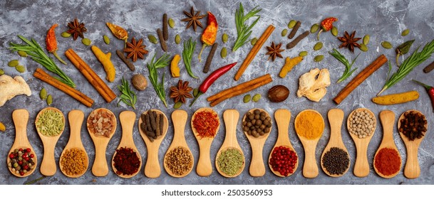 A set of spices on a gray background. Variety of spices from India. Food decoration design. Various spices, peppers and herbs close-up top view. Set of peppers, salt, herbs and spices for cooking. - Powered by Shutterstock