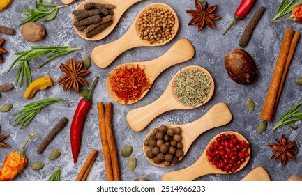 A set of spices on a gray background. Variety of spices from India. Food decoration design. Various spices, peppers and herbs close-up top view. Set of peppers, salt, herbs and spices for cooking. - Powered by Shutterstock