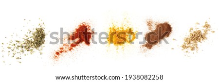 Set spices pile, oregano, red paprika powder, turmeric, cinnamon, ginger, isolated on white background, top view texture