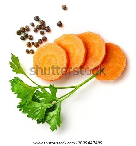 Set of spices for vegetable stock - carrot slices, parsley, onion and black pepper isolated on white background, from above