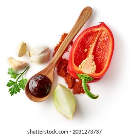 Set of spices - wooden spoon with barbecue sauce, red bell pepper, onion, garlic cloves, parsley and paprika powder isolated on white background, top view - Powered by Shutterstock