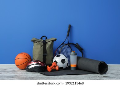 Set of sport equipment on floor near color wall - Shutterstock ID 1932113468