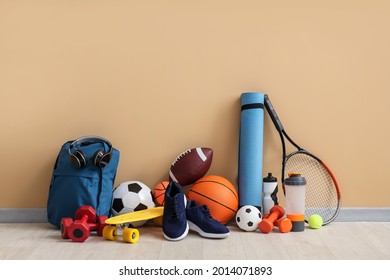 Set of sport equipment on floor near color wall - Powered by Shutterstock