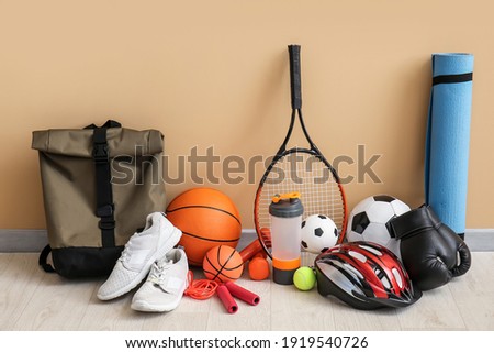 Set of sport equipment on floor near color wall