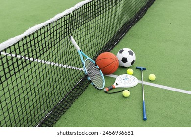 Set of sport equipment on green grass - Powered by Shutterstock