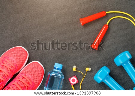 Set of sports accessories for fitness concept with exercise equipment on gray background
