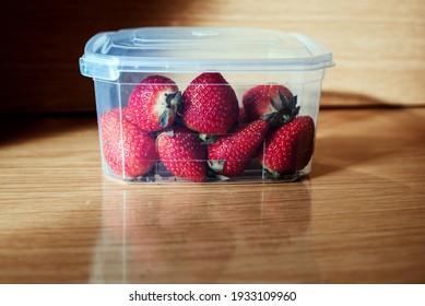 A Set Of Strawberries In A Plastic Tupperware Container. Bright Red Strawberries Ready To Eat Out