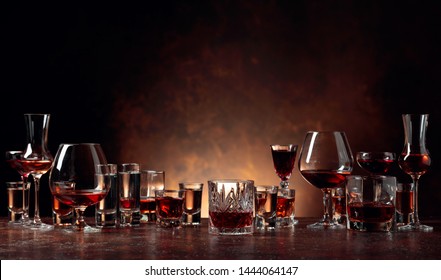 Set of strong alcoholic beverages in glasses on a brown background. In the presence of liquor, whiskey, vodka, rum, brandy, tequila.  - Shutterstock ID 1444064147