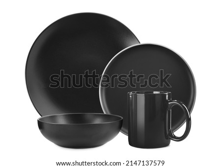 Set of stylish black dinnerware on white background